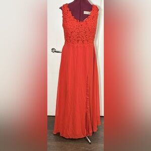 evening gown, lace-appliqué bodice and a long, flowing skirt with a high slit.